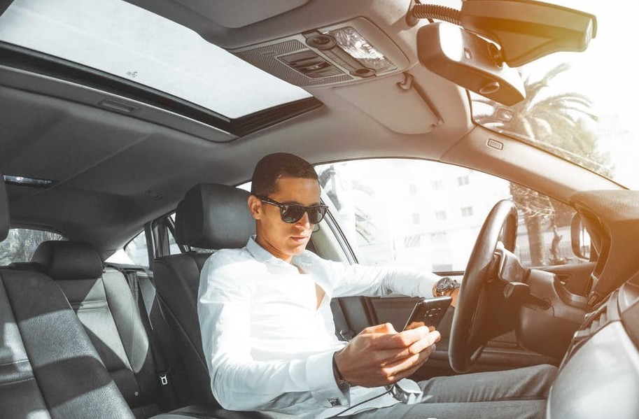 Driver in traffic checking his text messages