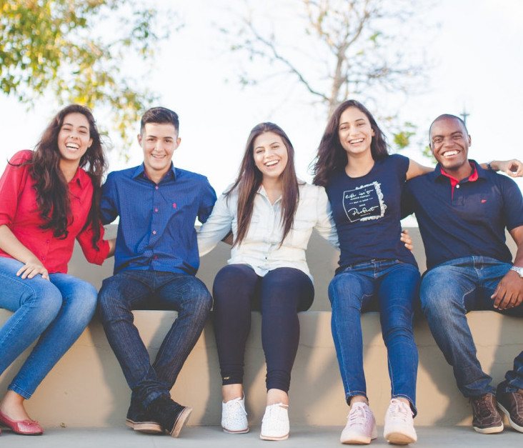 Group of male & female friends laughing together