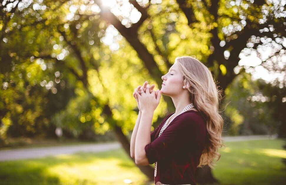 Woman praying in the yard